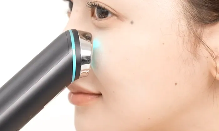medicube AGE-R Booster Pro device in use — electroporation technology on skin